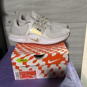 Women’s white and Gold Nike tennis shoes